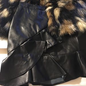 Asymmetric ruffle faux leather.